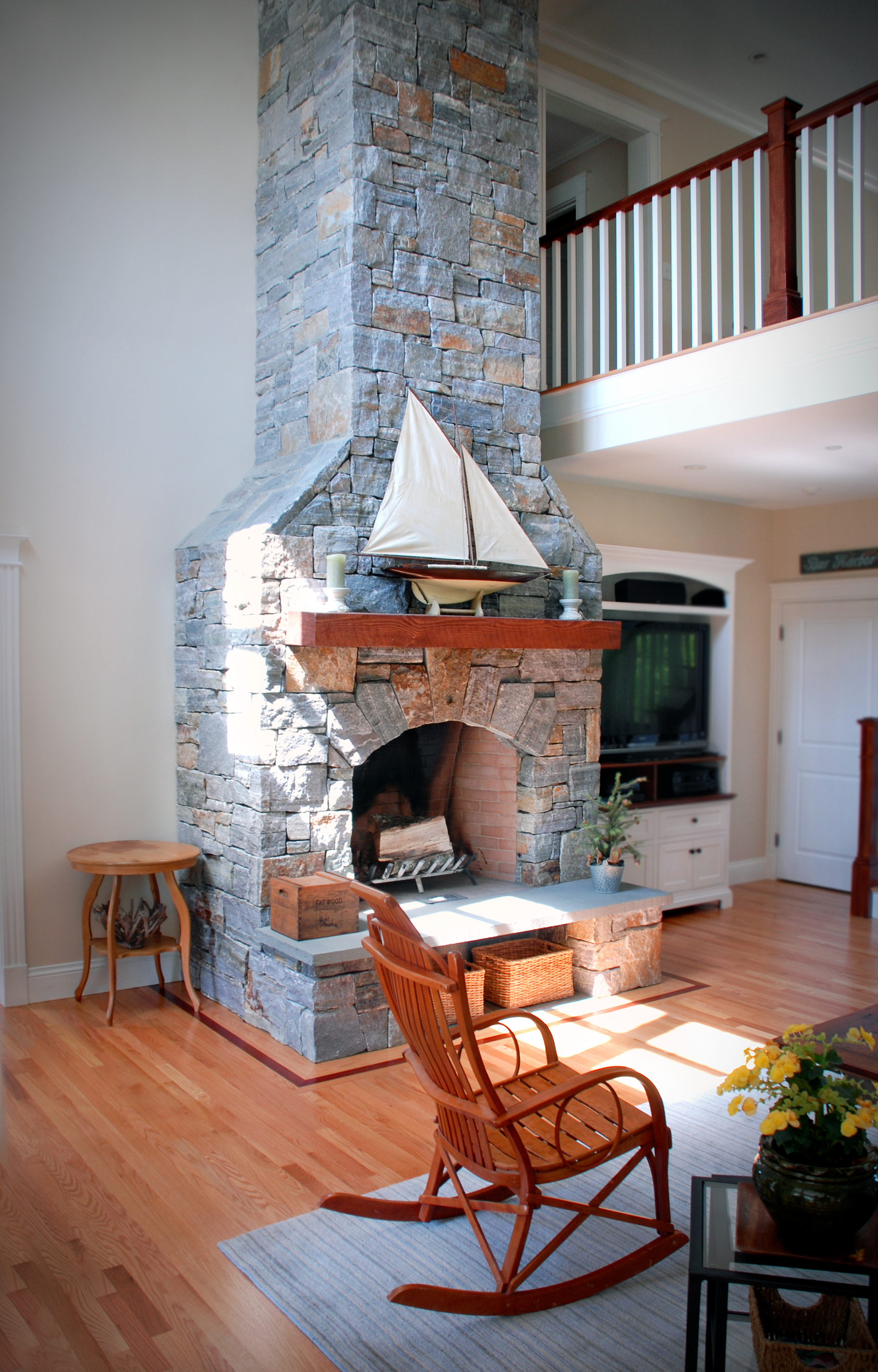 stone fireplace with model sailboat