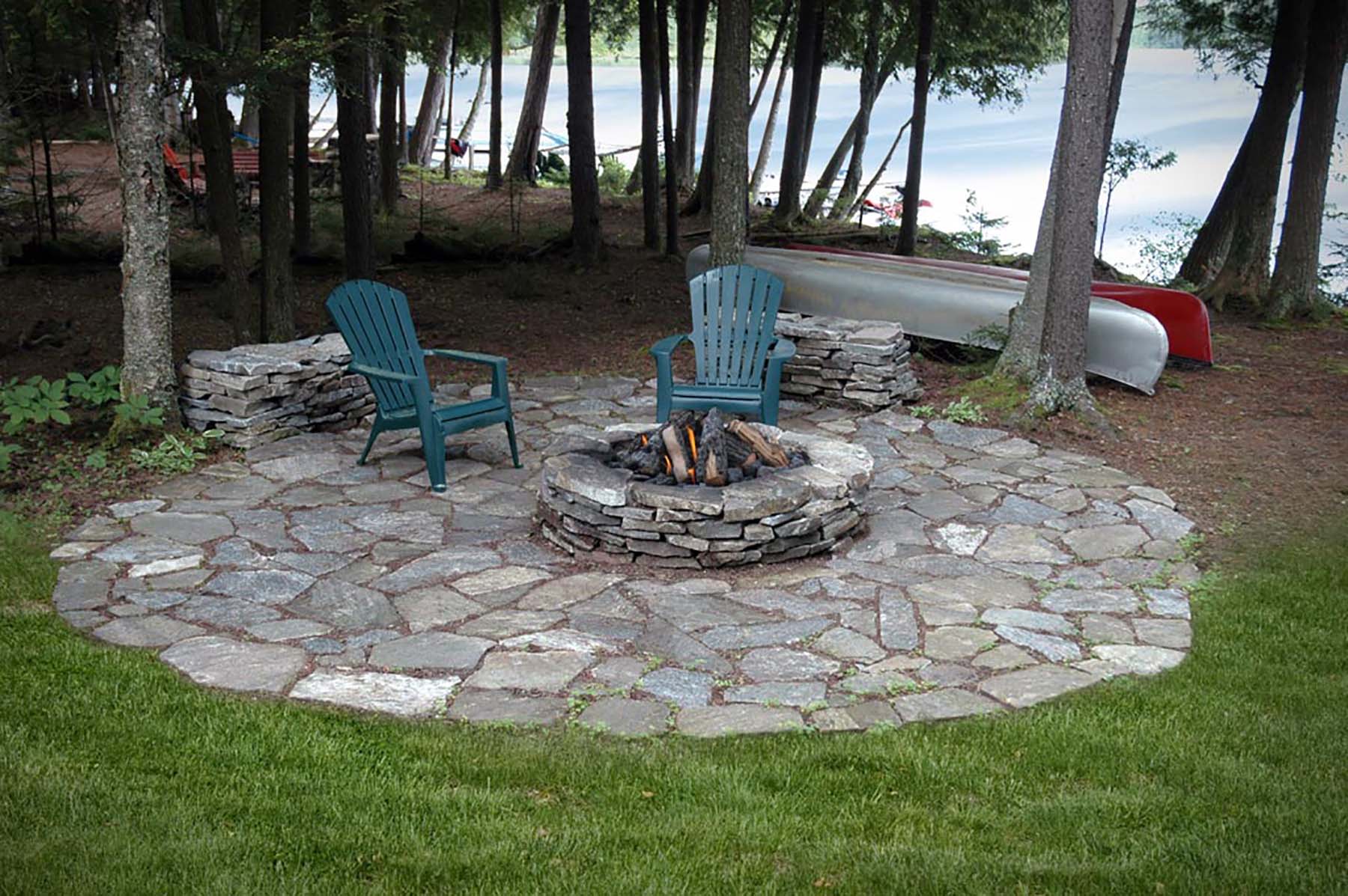 natural stone Ticonderoga granite outdoor fireplace in residential backyard