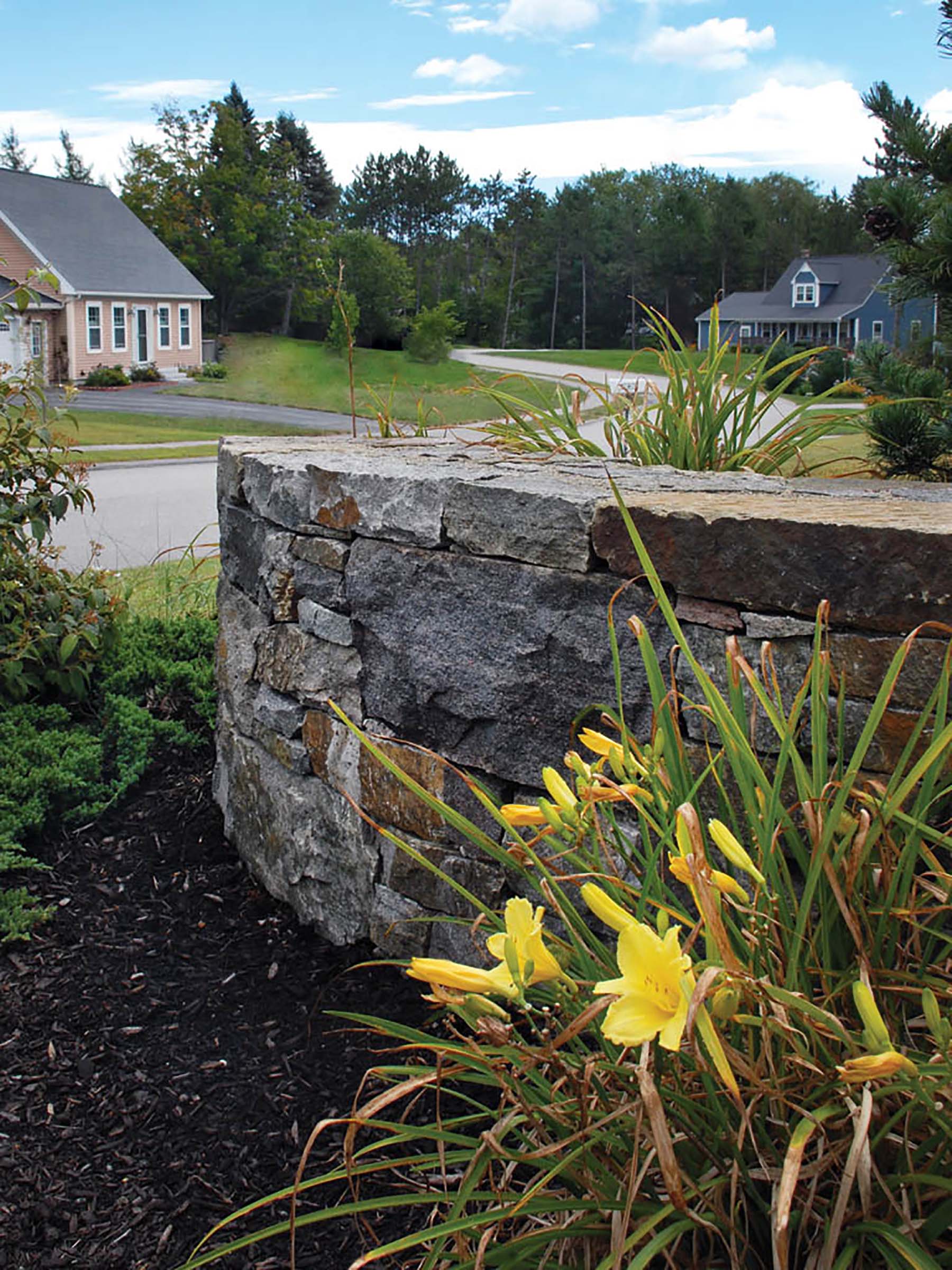 natural stone Ticonderoga wall in residential backyard