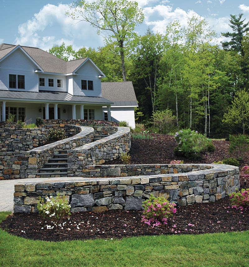 natural Adirondack stone wall and stairs in front of house